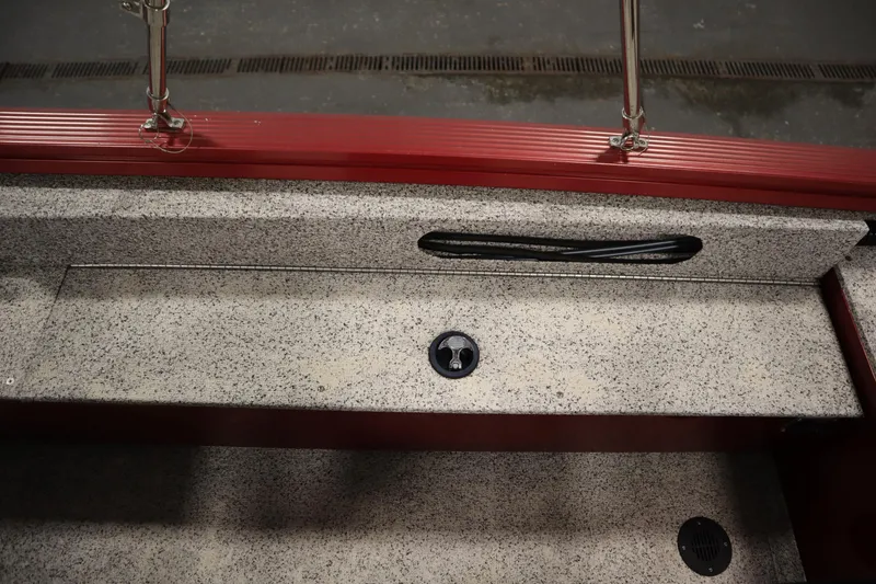 Slide: The Image of Interior view of 2023 Polar Kraft 2010 Outlander DC boat, featuring textured flooring and red trim. - 44