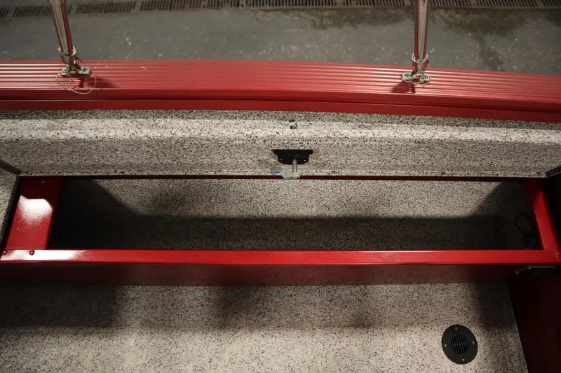 Slide: The Image of Open storage compartment in 2023 Polar Kraft 2010 OUTLANDER DC boat, featuring red and gray interior. - 45