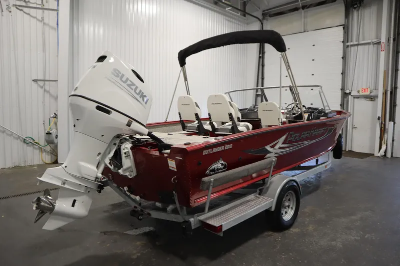 Slide: The Image of Red Polar Kraft 2010 OUTLANDER DC boat with Suzuki engine, 2023 model, in a garage. - 5