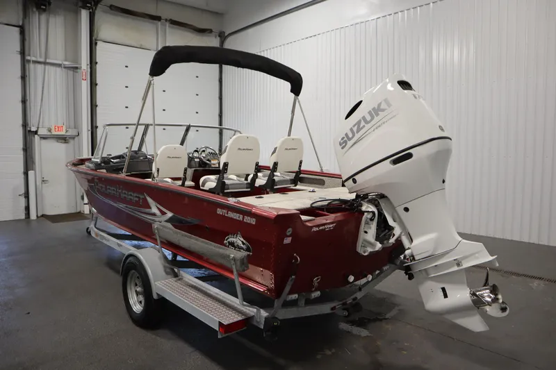 Slide: The Image of 2023 Polar Kraft Outlander DC boat with Suzuki engine in indoor storage. - 7