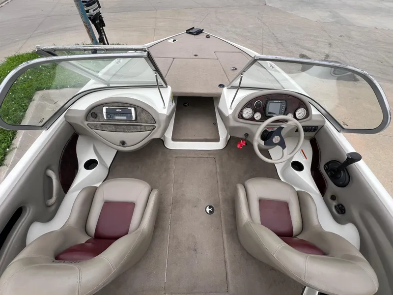 Slide: The Image of 2004 Ranger 180 Reata boat interior with dual seats and dashboard controls. - 11