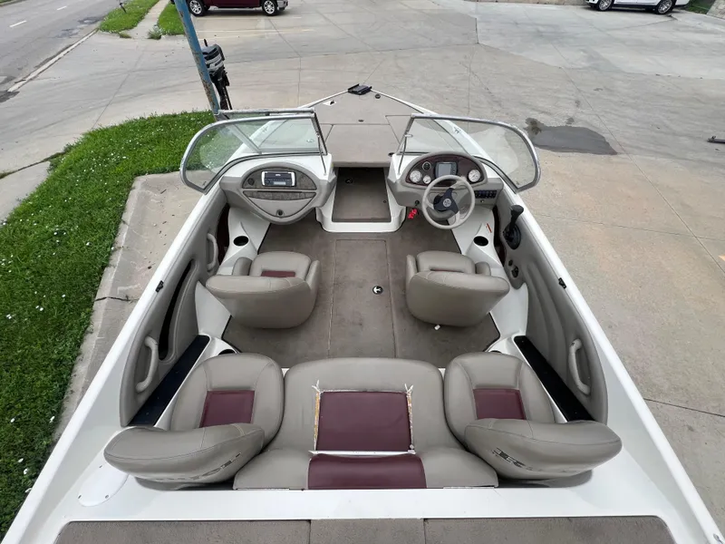 Slide: The Image of 2004 Ranger 180 Reata boat interior with seating and steering console. - 12