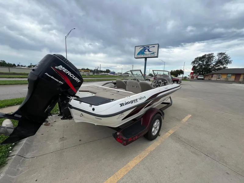 Slide: The Image of 2004 Ranger 180 Reata boat with Mercury engine parked outdoors. - 2