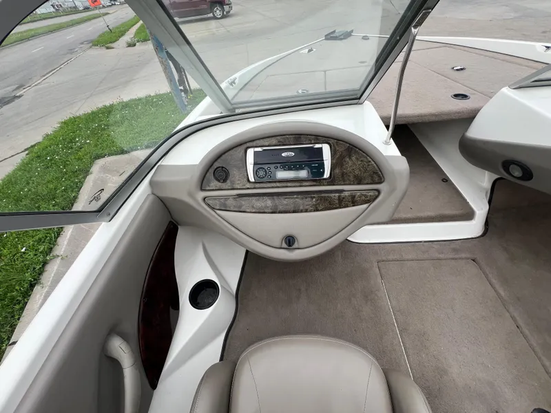 Slide: The Image of Interior of a 2004 Ranger 180 Reata boat, featuring dashboard and seating area. - 4