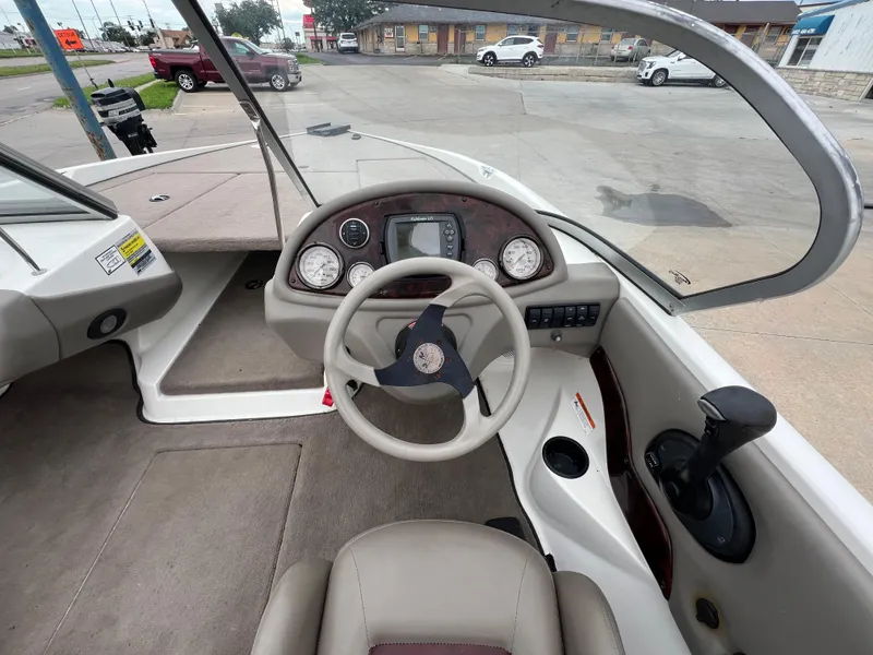 Slide: The Image of 2004 Ranger 180 Reata boat interior with steering wheel and dashboard controls. - 5