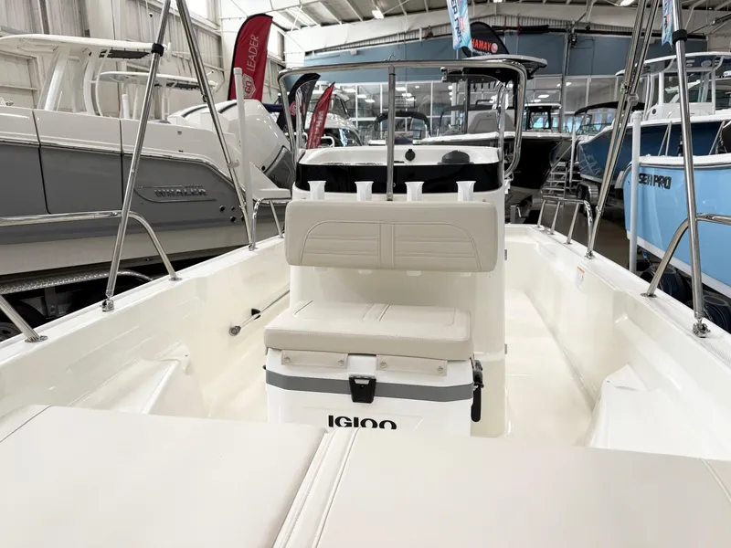 Slide: The Image of 2025 Boston Whaler 150 Montauk boat interior with seating and Igloo cooler. - 11