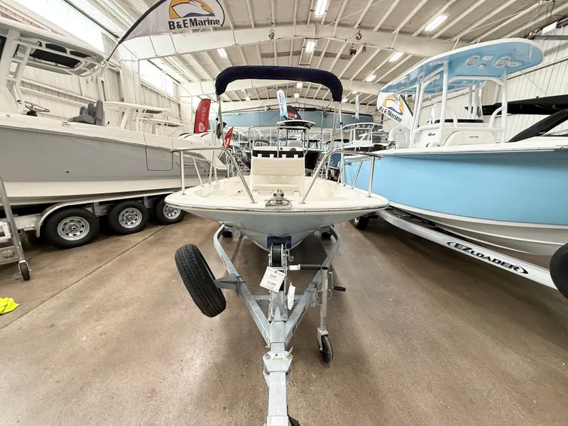 Slide: The Image of 2025 Boston Whaler 150 Montauk boat on trailer in showroom. - 4