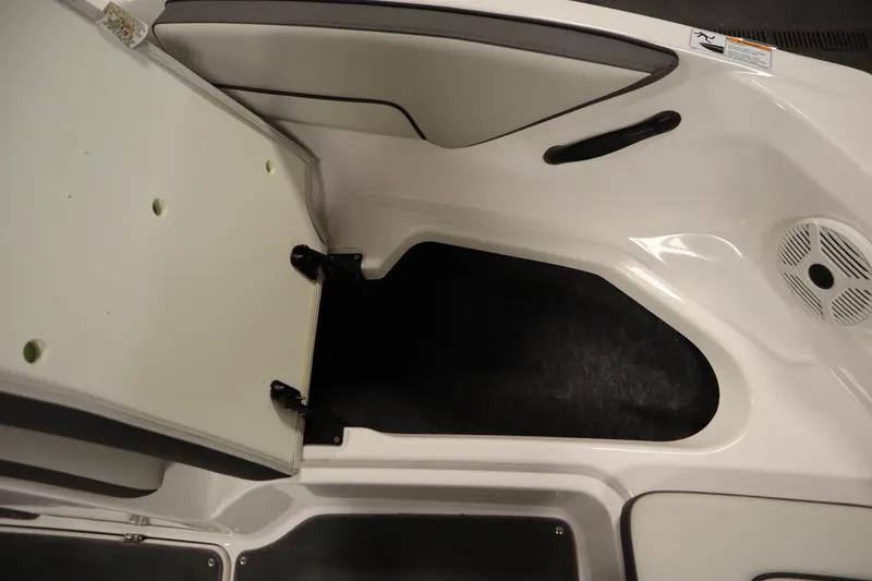 Slide: The Image of 2021 Yamaha Boats 190 AR storage compartment with open hatch and speaker. - 13