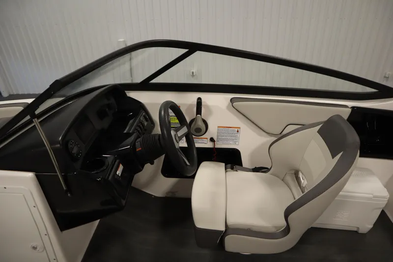 Slide: The Image of 2021 Yamaha Boats 190 AR interior cockpit with steering wheel and seating. - 17