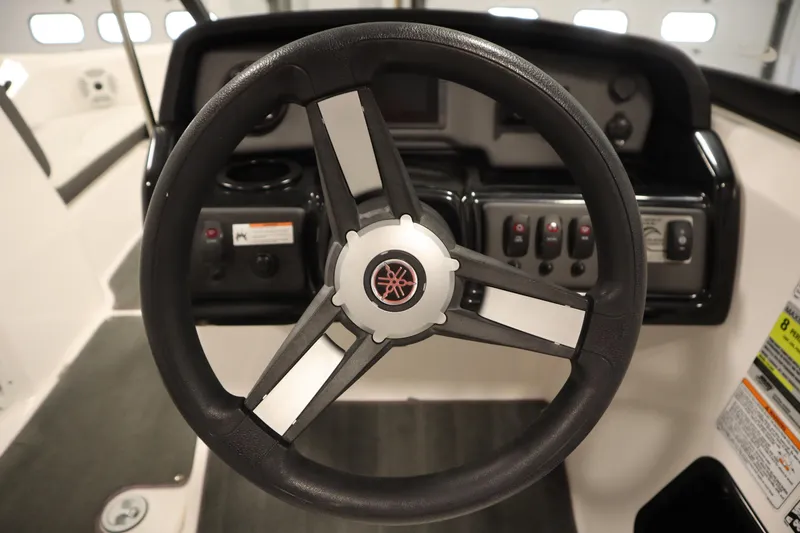 Slide: The Image of Steering wheel of 2021 Yamaha Boats 190 AR, featuring control panel and dashboard. - 19