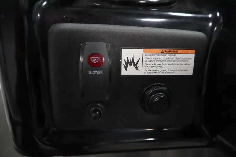 Slide: The Image of Blower switch and warning label on 2021 Yamaha Boats 190 AR dashboard. - 22