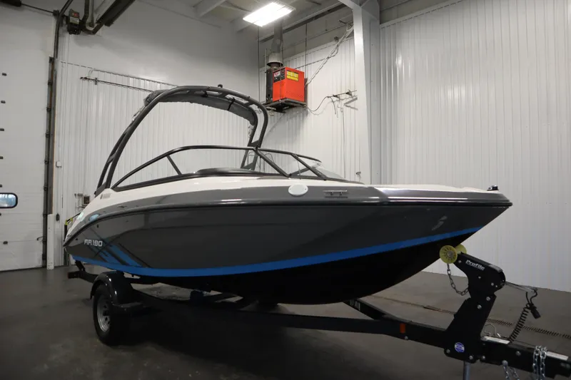 Slide: The Image of 2021 Yamaha Boats 190 AR in a garage, showcasing sleek design and modern features. - 3