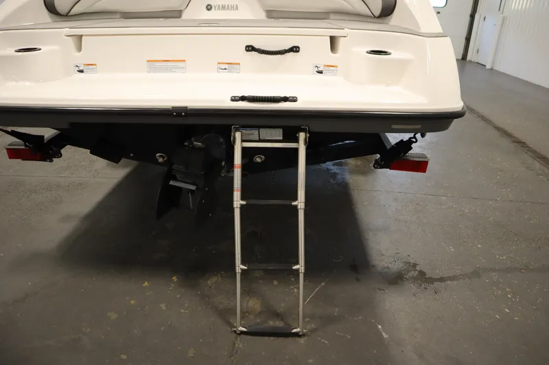 Slide: The Image of 2021 Yamaha Boats 190 AR rear view with ladder extended in a garage setting. - 40