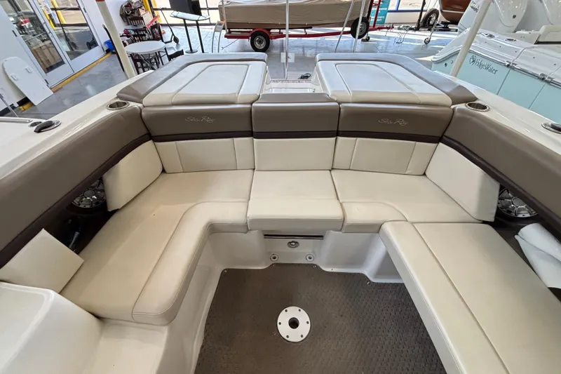Slide: The Image of 2013 Sea Ray 270 SLX boat interior with steering wheel and dashboard in a showroom. - 10