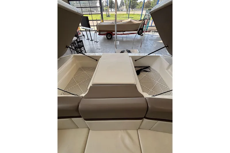 Slide: The Image of 2013 Sea Ray 270 SLX boat interior with beige seating and windshield. - 12