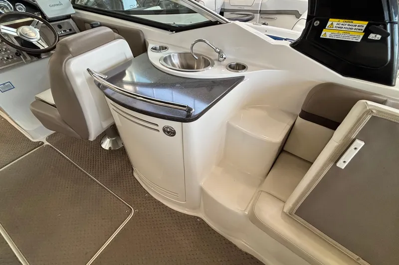 Slide: The Image of 2013 Sea Ray 270 SLX boat with teak swim platform in showroom. - 16