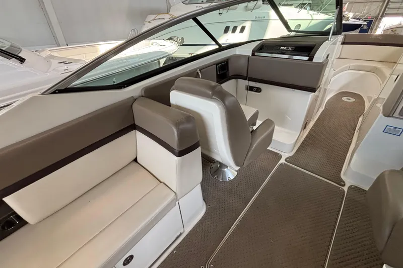 Slide: The Image of Interior of 2013 Sea Ray 270 SLX boat with beige seating and carpeted floor. - 17