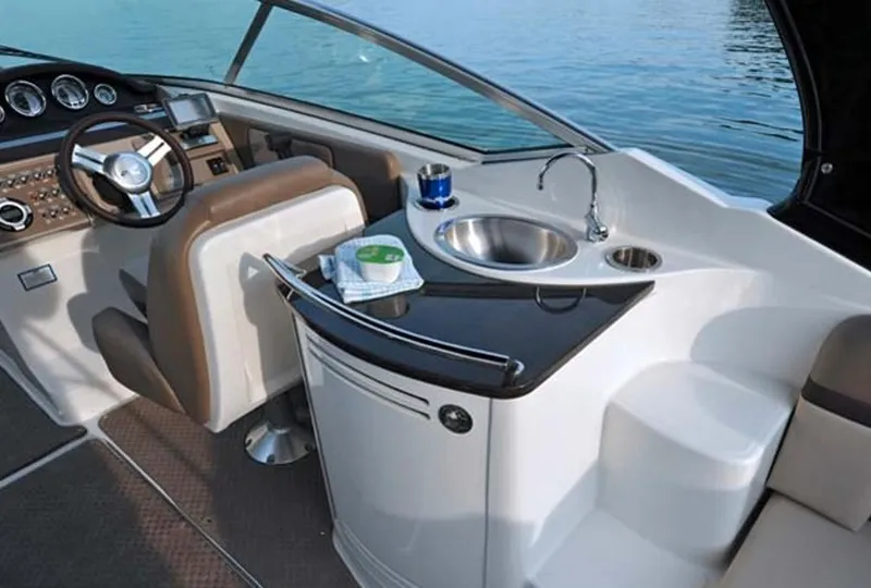 Slide: The Image of 2013 Sea Ray 270 SLX boat interior with cushioned seating in a showroom. - 3