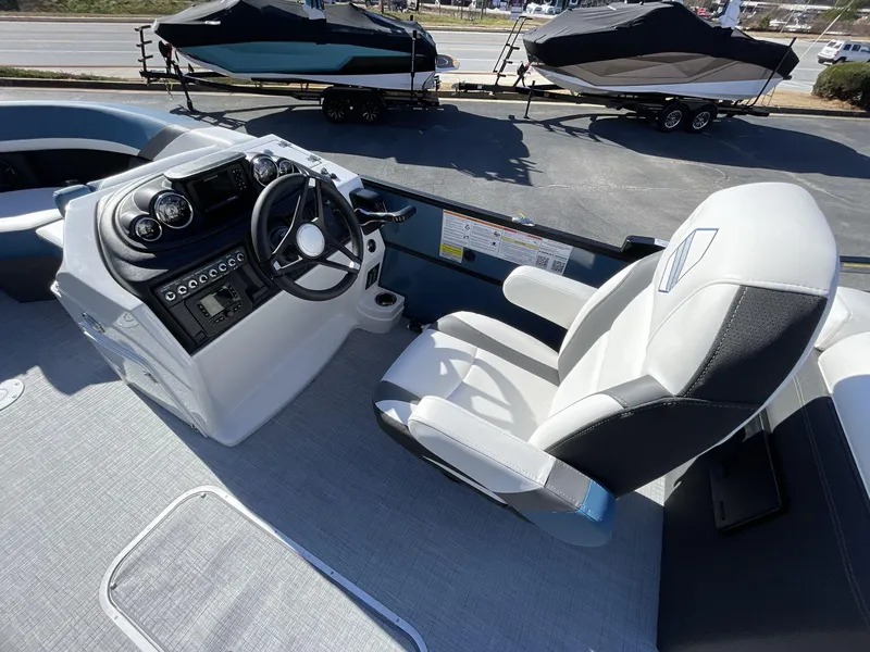 Slide: The Image of 2025 South Bay S222 RS boat interior with steering console and captain's chair. - 18