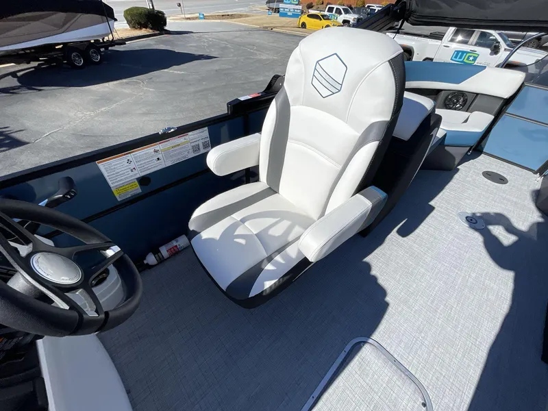 Slide: The Image of 2025 South Bay S222 RS boat interior with white captain's chair and steering wheel. - 21