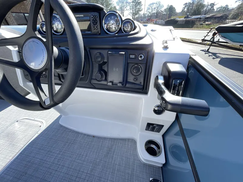 Slide: The Image of 2025 South Bay S222 RS boat dashboard with steering wheel and control panel. - 22