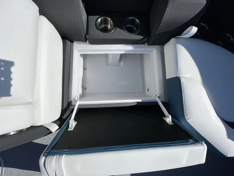 Slide: The Image of 2025 South Bay S222 RS boat seat storage compartment with cup holders, open view. - 24