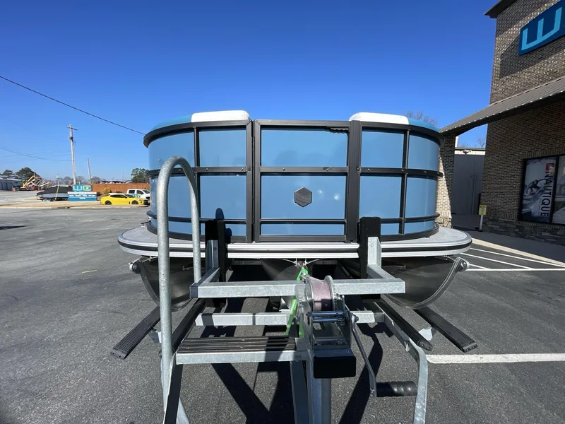 Slide: The Image of 2025 South Bay S222 RS pontoon boat on trailer, parked outdoors. - 27