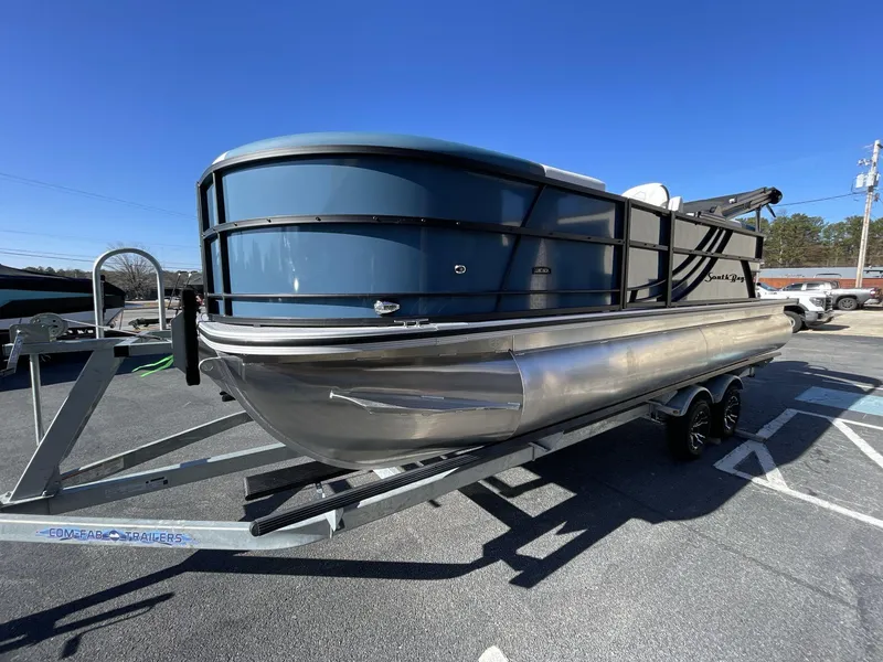 Slide: The Image of 2025 South Bay S222 RS pontoon boat on trailer under clear blue sky. - 28
