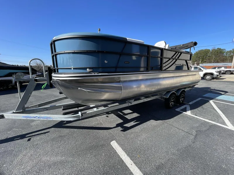 Slide: The Image of 2025 South Bay S222 RS pontoon boat on a trailer in a parking lot. - 3