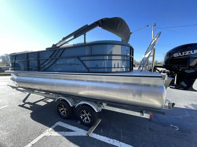 Slide: The Image of 2025 South Bay S222 RS pontoon boat on trailer, featuring sleek design and Suzuki outboard motor. - 30
