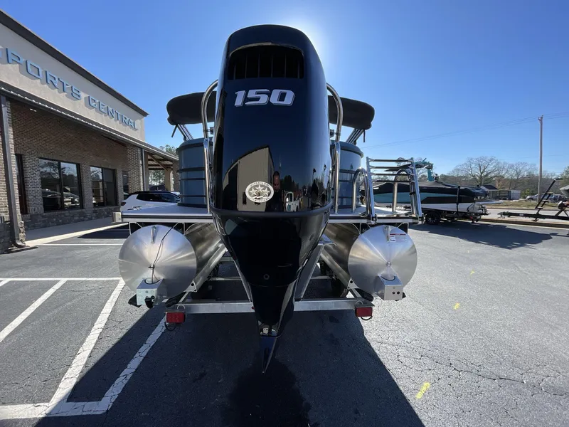 Slide: The Image of 2025 South Bay S222 RS pontoon boat with 150 horsepower engine, parked outside dealership. - 31