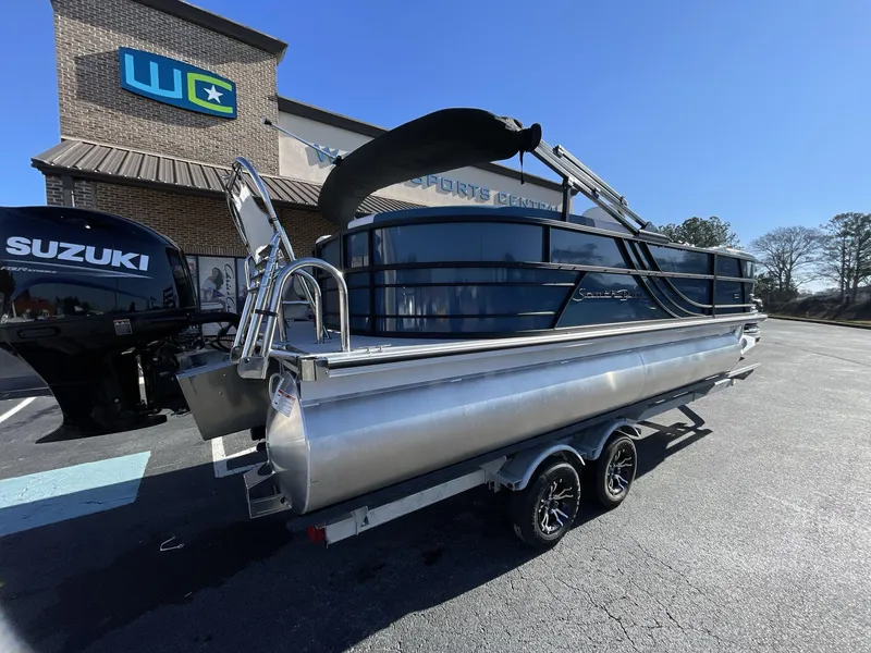 Slide: The Image of 2025 South Bay S222 RS pontoon boat on trailer, parked outside dealership. - 32