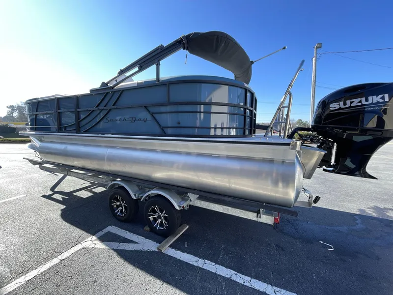 Slide: The Image of 2025 South Bay S222 RS pontoon boat on trailer with Suzuki outboard motor. - 5