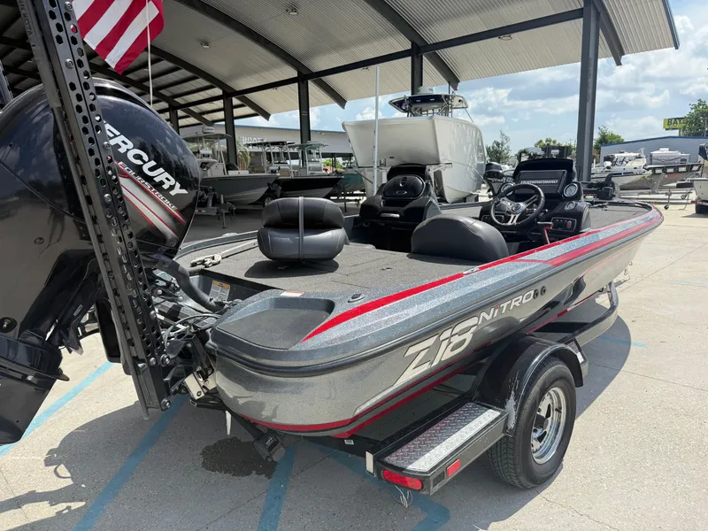 Slide: The Image of 2016 Nitro Z18 boat with Mercury engine, parked under a canopy, featuring sleek design and modern equipment. - 5