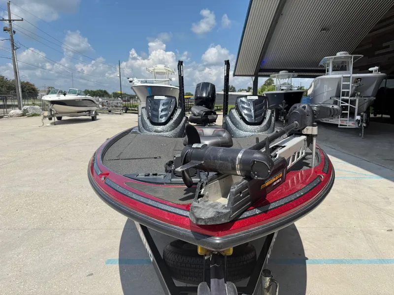 Slide: The Image of 2016 Nitro Z18 boat with Minn Kota trolling motor, parked outdoors under a clear sky. - 6