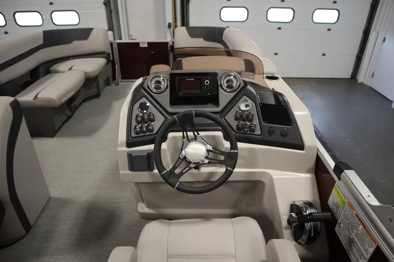 Slide: The Image of 2022 Sylvan 21 L-1 CRS boat interior with steering console and seating. - 12