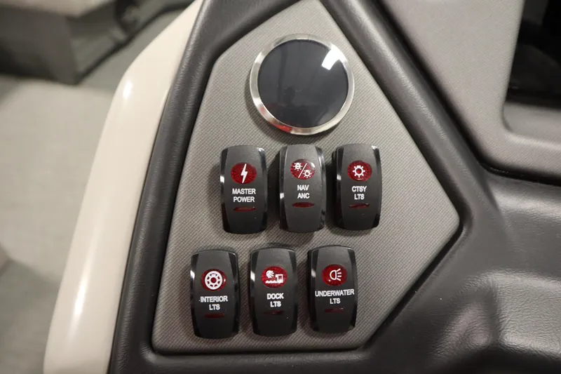 Slide: The Image of Control panel of 2022 Sylvan 21 L-1 CRS boat with various switches. - 15