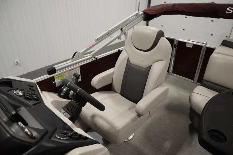 Slide: The Image of 2022 Sylvan 21 L-1 CRS boat interior with steering wheel and captain's chair. - 20