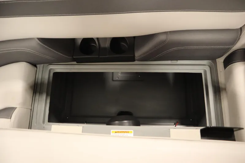 Slide: The Image of 2022 Sylvan 21 L-1 CRS boat storage compartment with cup holders and cushioned seating. - 24