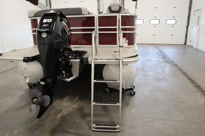 Slide: The Image of 2022 Sylvan 21 L-1 CRS pontoon boat with 50 HP Mercury outboard motor in a garage. - 29
