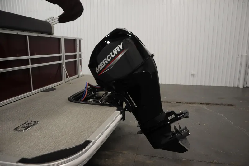 Slide: The Image of 2022 Sylvan 21 L-1 CRS boat with Mercury outboard motor in a garage setting. - 30