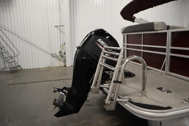 Slide: The Image of 2022 Sylvan 21 L-1 CRS pontoon boat with Mercury outboard motor in a storage facility. - 31