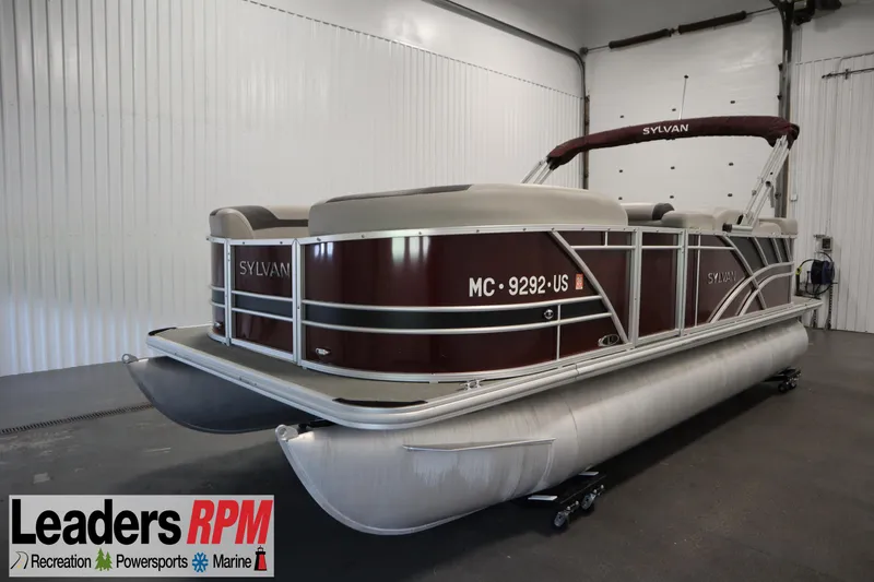 Slide: The Image of 2022 Sylvan 21 L-1 CRS pontoon boat in showroom, featuring maroon and silver design. - 35