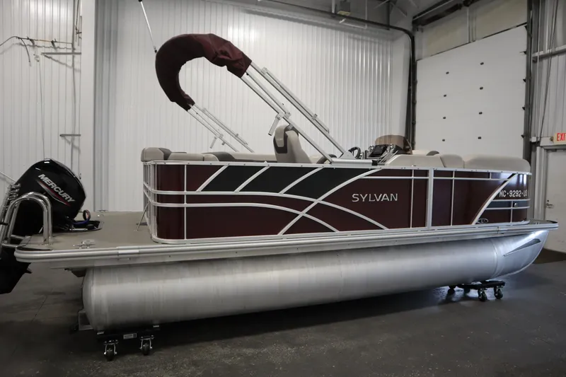 Slide: The Image of 2022 Sylvan 21 L-1 CRS pontoon boat with Mercury engine in indoor storage. - 38