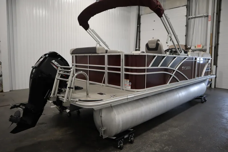Slide: The Image of 2022 Sylvan 21 L-1 CRS pontoon boat with Mercury outboard motor in a garage setting. - 39