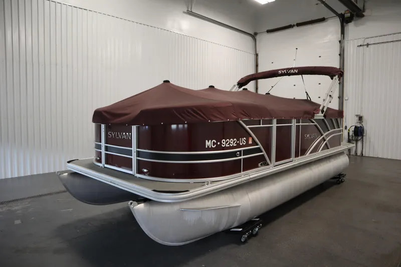 Slide: The Image of 2022 Sylvan 21 L-1 CRS pontoon boat with maroon cover in indoor storage. - 43