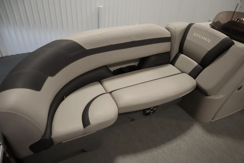 Slide: The Image of 2022 Sylvan 21 L-1 CRS boat interior seating, featuring beige and black upholstery. - 7