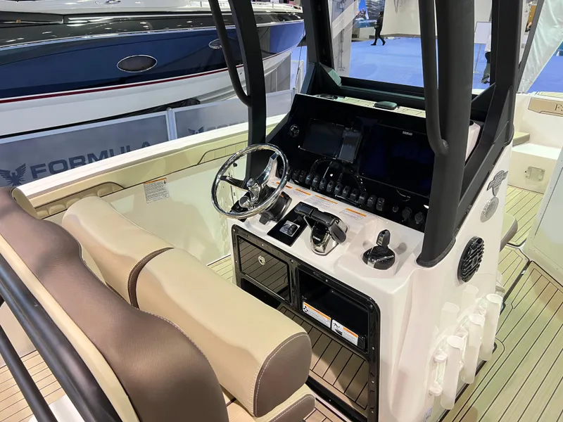 Slide: The Image of 2025 Yamaha Boats 255 FSH Sport H dashboard with steering wheel and controls. - 8