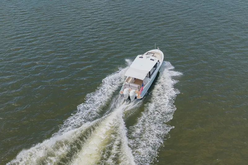 Slide: The Image of Aerial view of 2025 MJM 3 boat cruising on open water. - 12