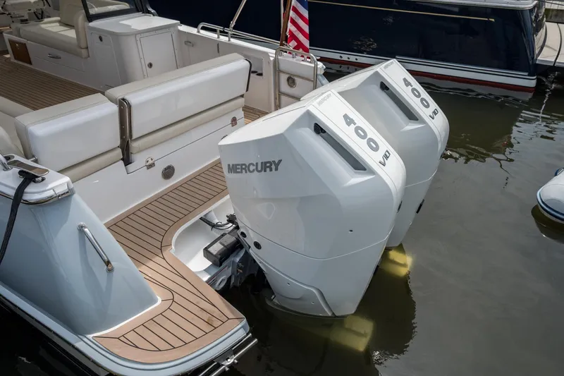Slide: The Image of 2025 MJM 3 boat with twin Mercury 400 V10 outboard engines, docked in water. - 16